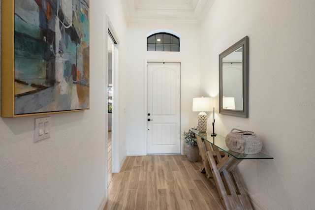 interior space with light hardwood / wood-style floors and crown molding