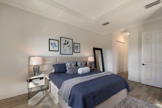 bedroom with crown molding and a closet