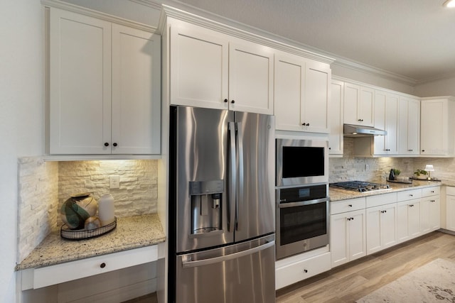 kitchen with decorative backsplash, light stone countertops, white cabinetry, and stainless steel appliances