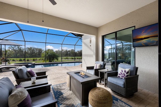 view of patio / terrace with glass enclosure, a swimming pool with hot tub, and an outdoor living space with a fire pit