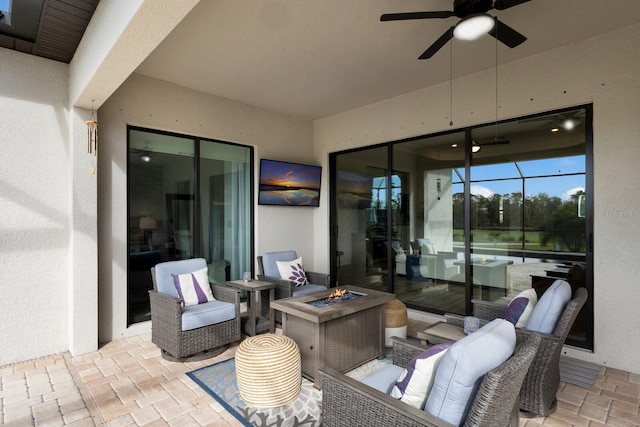 view of patio / terrace featuring an outdoor living space with a fire pit and ceiling fan