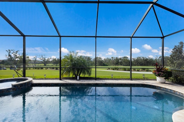 view of pool featuring glass enclosure, an in ground hot tub, and a yard