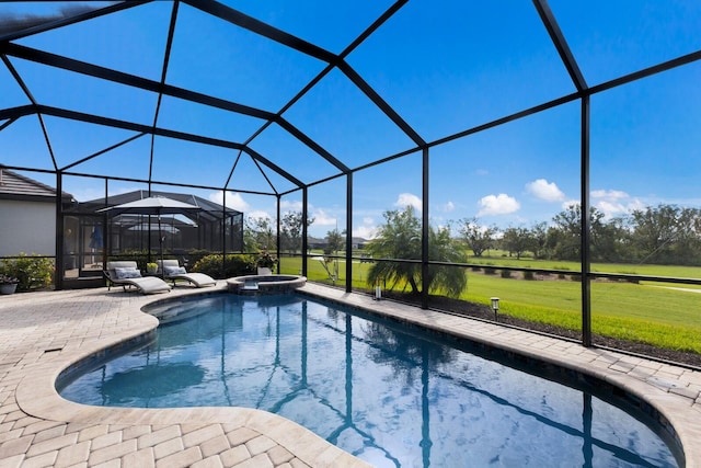 view of swimming pool featuring a lawn, glass enclosure, an in ground hot tub, and a patio