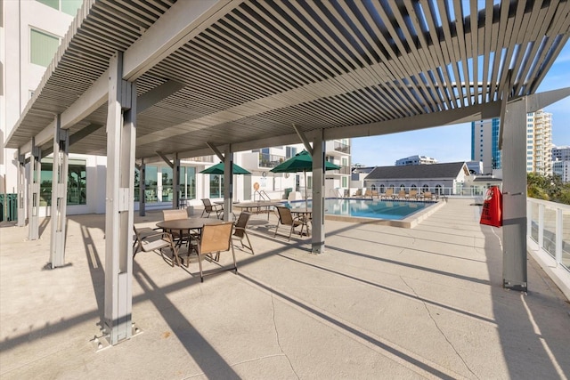 view of patio / terrace with a pergola and a community pool