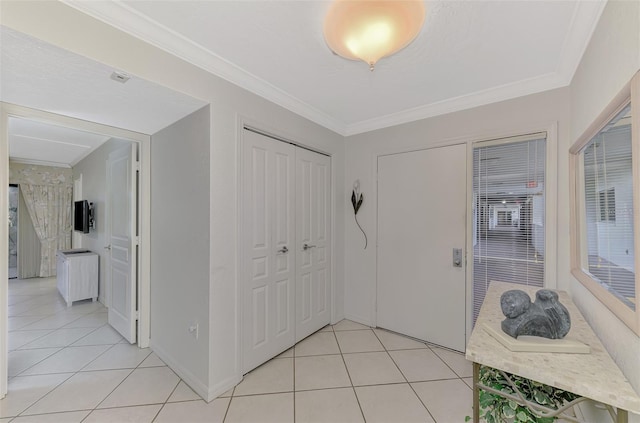 tiled foyer featuring ornamental molding