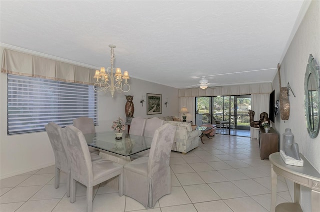 dining area featuring ceiling fan with notable chandelier, vaulted ceiling, crown molding, and light tile patterned flooring