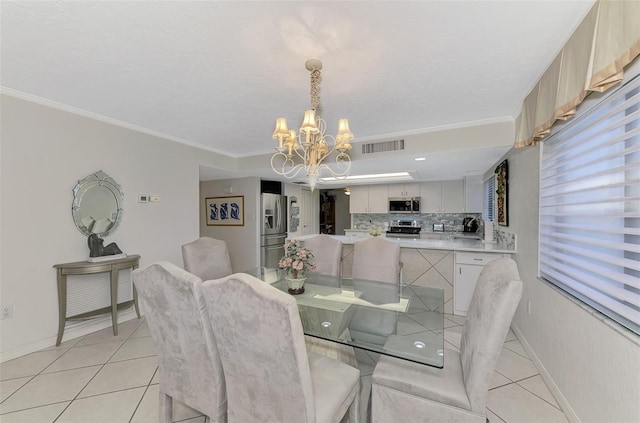 dining space with light tile patterned floors, ornamental molding, and a notable chandelier