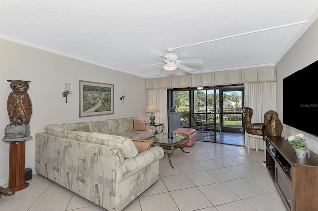 tiled living room featuring ceiling fan and crown molding