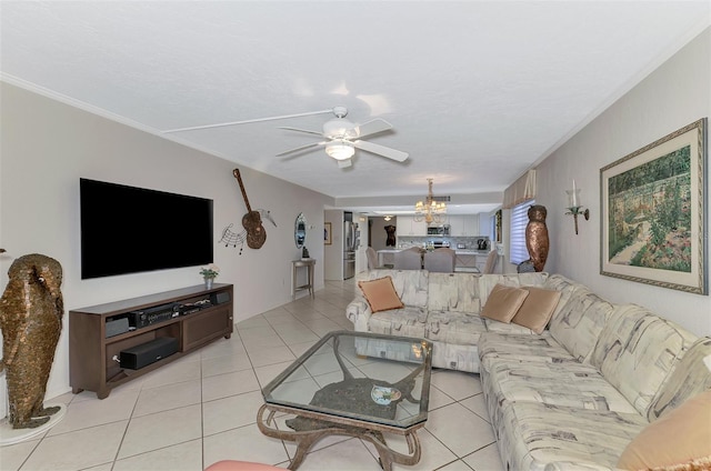 living room with crown molding, light tile patterned flooring, and ceiling fan with notable chandelier