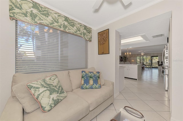 tiled living room with crown molding and ceiling fan with notable chandelier