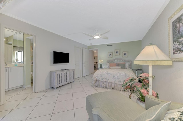 tiled bedroom featuring ceiling fan and ensuite bathroom