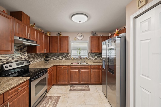 kitchen with backsplash, light stone counters, sink, and stainless steel appliances