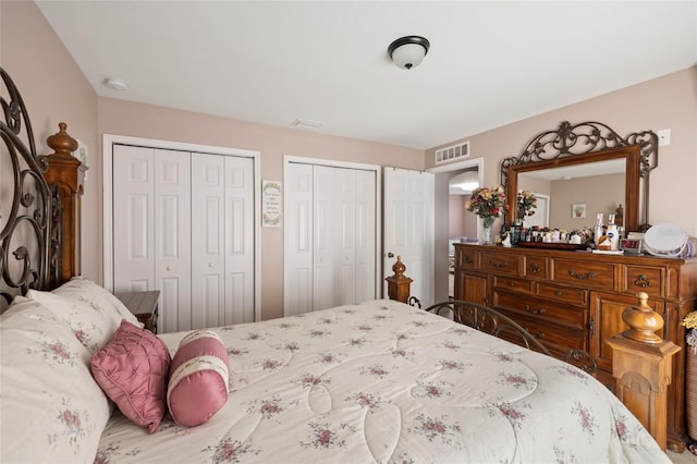 bedroom with multiple closets