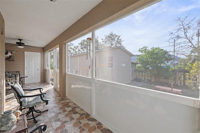 sunroom featuring ceiling fan