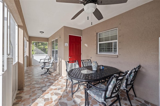 sunroom featuring ceiling fan