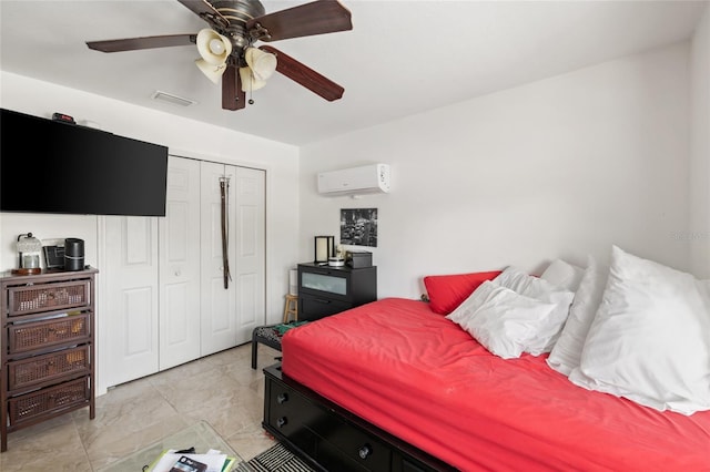 bedroom with a wall mounted AC, a closet, and ceiling fan