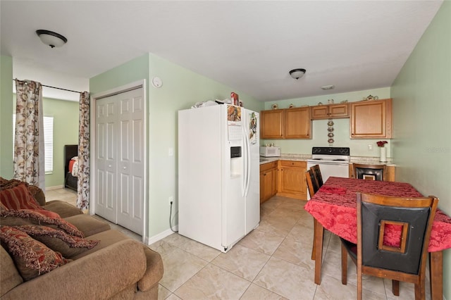 kitchen with light tile patterned floors and white appliances