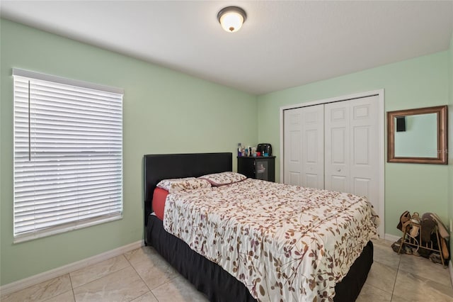 tiled bedroom with a closet