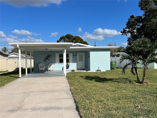 view of front of property with a carport, a porch, and a front yard