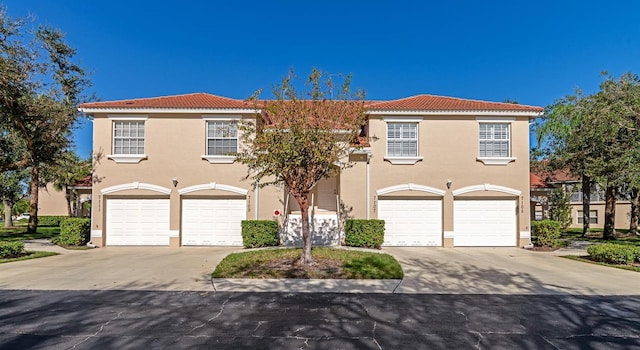 mediterranean / spanish-style home featuring a garage