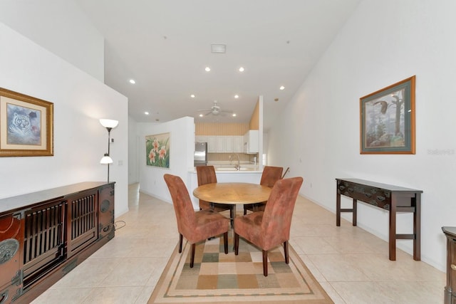 tiled dining space featuring ceiling fan and sink