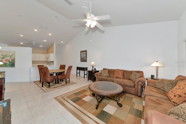 living room featuring ceiling fan, light tile patterned floors, and high vaulted ceiling