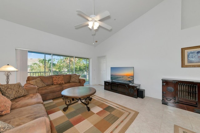 tiled living room with ceiling fan and high vaulted ceiling