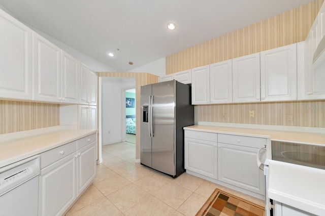 kitchen featuring white cabinetry, stainless steel fridge with ice dispenser, stove, white dishwasher, and light tile patterned flooring