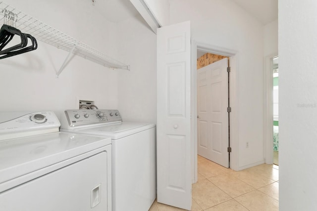 laundry room with washer and dryer and light tile patterned flooring