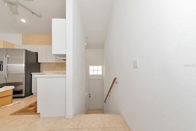 kitchen featuring white cabinetry, stainless steel fridge with ice dispenser, light tile patterned floors, and ceiling fan