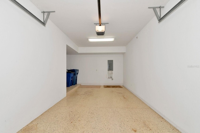 garage with electric panel and a garage door opener