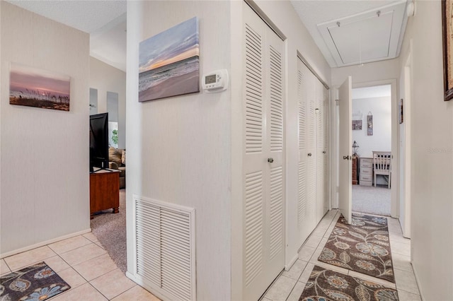 hall featuring light tile patterned floors