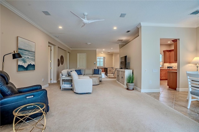 carpeted living room featuring ceiling fan and ornamental molding