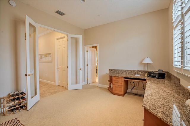 carpeted office space featuring french doors