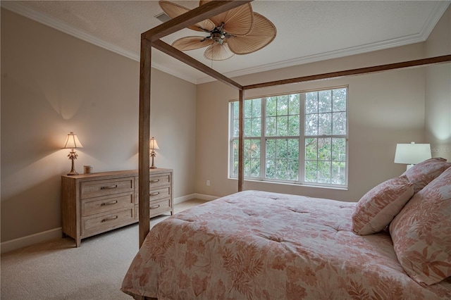 carpeted bedroom featuring ornamental molding, a textured ceiling, and ceiling fan