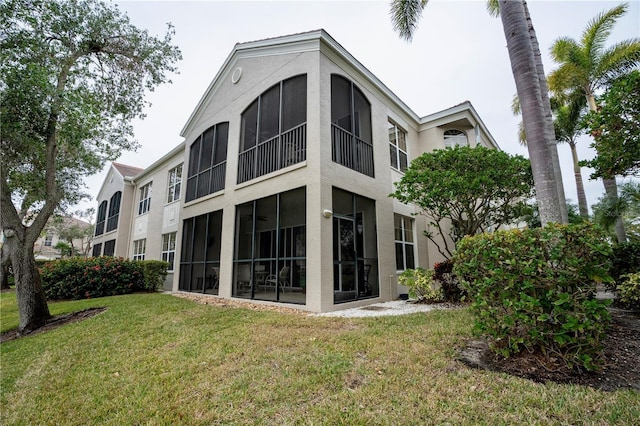 rear view of property with a lawn