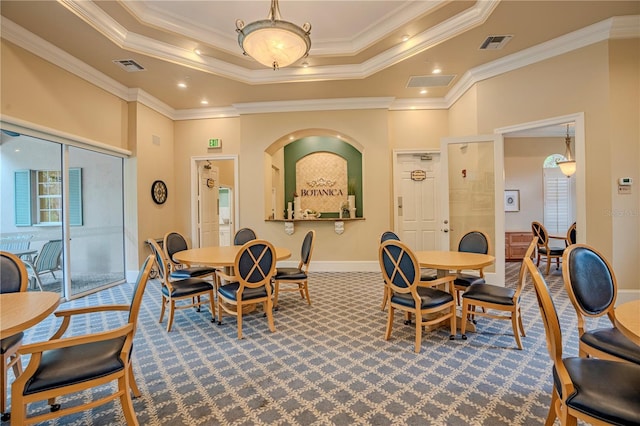 dining area featuring ornamental molding, carpet flooring, and a tray ceiling