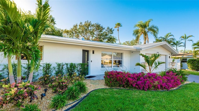 ranch-style house with a front lawn and a garage