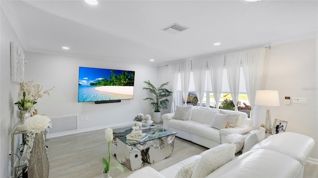 living room featuring light wood-type flooring and ornamental molding