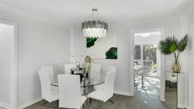 dining area with an inviting chandelier, wood-type flooring, and ornamental molding