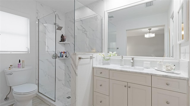 bathroom with vanity, toilet, and a shower with door