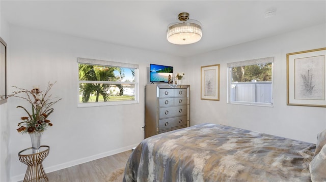 bedroom featuring light hardwood / wood-style floors and multiple windows