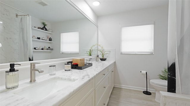 bathroom featuring hardwood / wood-style flooring, vanity, a shower with shower curtain, and toilet