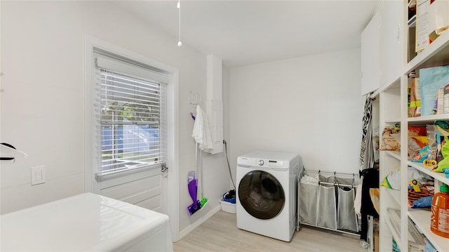 laundry room featuring washer / clothes dryer and light hardwood / wood-style flooring