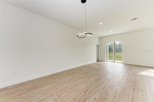 spare room featuring light hardwood / wood-style flooring