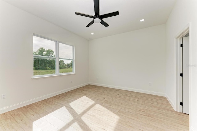 spare room with light hardwood / wood-style flooring and ceiling fan