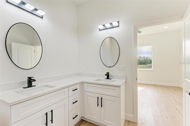 bathroom featuring hardwood / wood-style floors and vanity