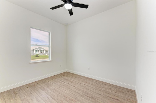 empty room with ceiling fan and light hardwood / wood-style flooring