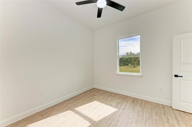 empty room with ceiling fan and light hardwood / wood-style flooring