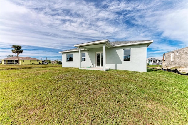 rear view of house with a lawn